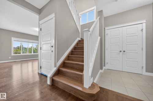 Hardwood staircase with white risers and railing - 3639 15A Street Nw, Edmonton, AB - Indoor Photo Showing Other Room