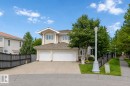 Two-story stucco residence featuring a dual garage, pitched roof, and mature front landscaping - 928 Heacock Road Nw, Edmonton, AB  - Outdoor 