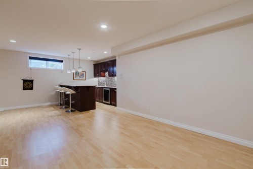 Open concept recreation space featuring light wood-finish flooring - 928 Heacock Road Nw, Edmonton, AB - Indoor Photo Showing Other Room