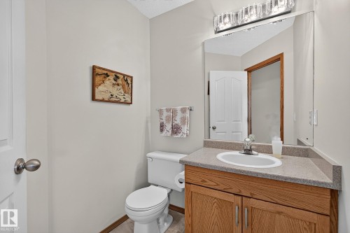 Guest bathroom on the main floor with vanity, light wood-finish cabinetry, and an integrated white basin - 385 Meadowview Terrace, Sherwood Park, AB - Indoor Photo Showing Bathroom