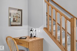 Staircase featuring wood railings and carpeted treads - 