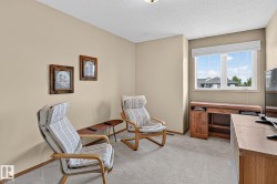 Bedroom 3 is a carpeted room with a large window and neutral-toned walls - 