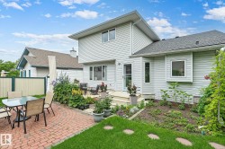 Expansive backyard featuring a red brick paver patio and a separate deck - 