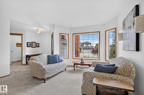 Bright living area featuring a bay window with wood trim - 385 Meadowview Terrace, Sherwood Park, AB - Indoor Photo Showing Living Room