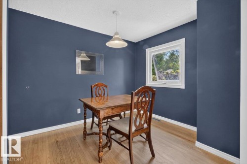 Room featuring wood-finish flooring and a single window with white trim - 11934 43 Street Nw, Edmonton, AB - Indoor Photo Showing Dining Room