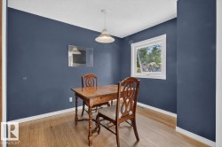 Room featuring wood-finish flooring and a single window with white trim - 