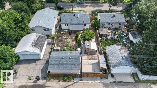 Two-story residential property featuring a gray shingle roof and light-colored siding - 11934 43 Street Nw, Edmonton, AB - Outdoor