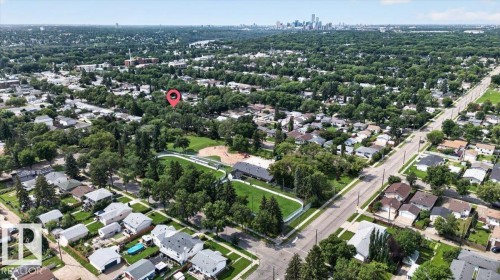 Aerial perspective showcasing a residential neighborhood with a prominent community park featuring a baseball diamond and green spaces - 11934 43 Street Nw, Edmonton, AB - Outdoor With View