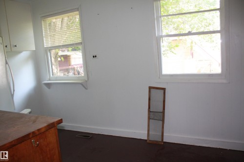 White walls with two single-pane windows featuring white trim - 5227 51 Street, Redwater, AB - Indoor Photo Showing Other Room
