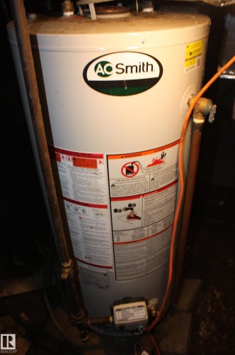 AO Smith water heater with visible plumbing connections - 5227 51 Street, Redwater, AB - Indoor Photo Showing Basement