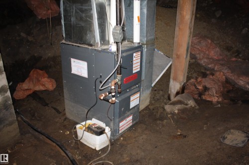 Central HVAC unit with visible ductwork and copper piping - 5227 51 Street, Redwater, AB - Indoor Photo Showing Basement