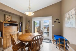Dining area featuring a vaulted ceiling and tile flooring - 