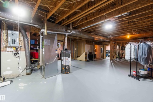 Unfinished basement with exposed wood joist ceiling, concrete flooring, and partial framing for future expansion - 6320 166 Avenue Nw, Edmonton, AB - Indoor Photo Showing Basement