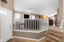 Entryway featuring tile flooring, a white paneled door with an arched glass insert, and a partial carpeted staircase - 6320 166 Avenue Nw, Edmonton, AB  - Indoor Photo Showing Other Room 