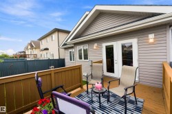 Rear deck with wood-finish flooring and sturdy wood railing - 