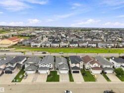 Residential community featuring diverse home styles and manicured lawns - 