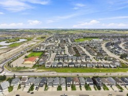 Expansive aerial showcasing a residential development with numerous single-family homes - 