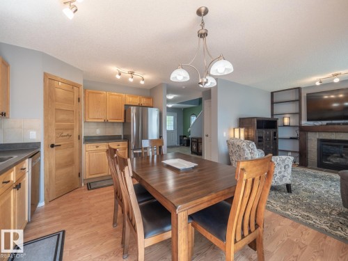 #42 450 Hyndman Cr Nw, Edmonton, AB - Indoor Photo Showing Dining Room With Fireplace
