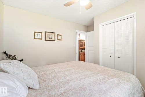 Room featuring neutral wall tones, a ceiling fan with integrated lighting, and white louvered bifold closet doors - 4921 47 Avenue, Legal, AB - Indoor Photo Showing Bedroom