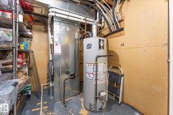 Utility area featuring a water heater and furnace - 