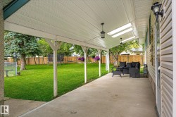 Covered concrete patio featuring white vinyl soffit and recessed lighting - 