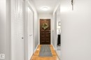 Entryway featuring wood-finish flooring, a paneled front door, white louvered bifold closet doors, and recessed ceiling lighting - 4921 47 Avenue, Legal, AB  - Indoor Photo Showing Other Room 