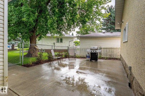 Concrete patio with an adjacent chain-link fence and gate - 4921 47 Avenue, Legal, AB - Outdoor