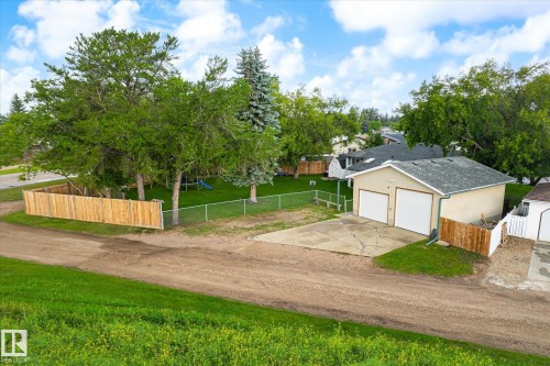 Detached two-car garage with white overhead doors and an asphalt shingle roof - 4921 47 Avenue, Legal, AB - Outdoor