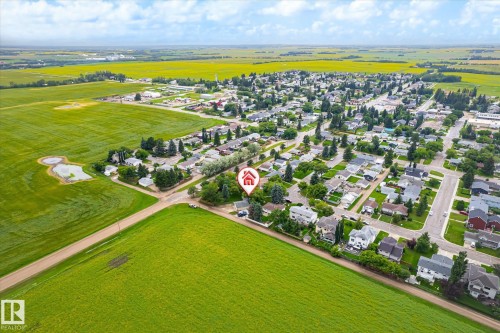 Aerial perspective showcasing a residential community surrounded by expansive agricultural fields - 4921 47 Avenue, Legal, AB - Outdoor With View