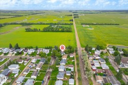 Aerial perspective showcasing a residential area bordered by expansive green fields - 