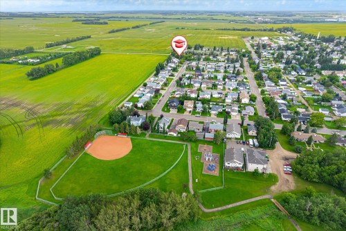 Aerial perspective of a residential community bordered by agricultural fields - 4921 47 Avenue, Legal, AB - Outdoor With View