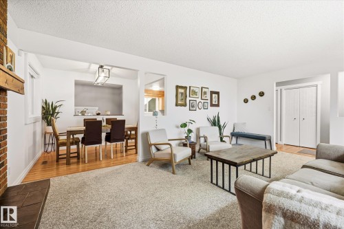 Spacious living area featuring light-toned carpeting and white walls - 4921 47 Avenue, Legal, AB - Indoor Photo Showing Living Room