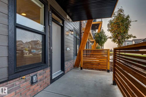 Contemporary exterior featuring horizontal siding, brick accents, and a concrete patio - #1 16231 19 Av Sw, Edmonton, AB - Outdoor With Exterior