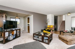 Living area featuring light-toned carpet flooring and a neutral color palette - 