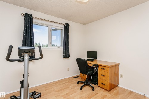 Bright room featuring wood-finish flooring and a double window - 18316 78 Avenue Nw, Edmonton, AB - Indoor Photo Showing Other Room