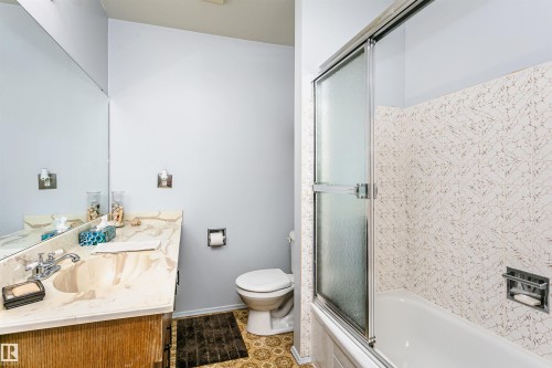 Bathroom featuring a built-in vanity with an integrated sink and a full-width mirror - 18316 78 Avenue Nw, Edmonton, AB - Indoor Photo Showing Bathroom