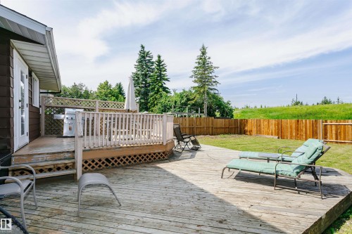 Expansive multi-level wooden deck with lattice detailing, featuring direct access from the property - 18316 78 Avenue Nw, Edmonton, AB - Outdoor With Deck Patio Veranda