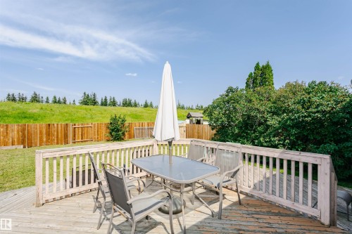 Expansive wooden deck with a slatted railing, providing an outdoor living area - 18316 78 Avenue Nw, Edmonton, AB - Outdoor With Deck Patio Veranda