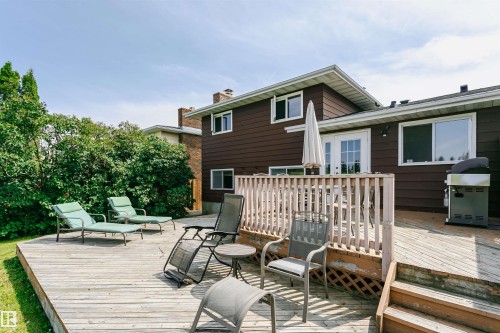 Expansive wood deck featuring a protective railing and direct access to the home via French doors - 18316 78 Avenue Nw, Edmonton, AB - Outdoor With Deck Patio Veranda With Exterior