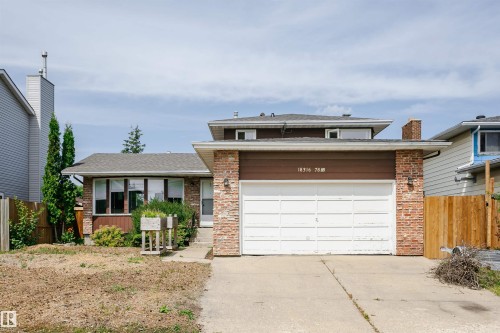 Brick and siding exterior featuring a two-car garage, concrete driveway, and front entry - 18316 78 Avenue Nw, Edmonton, AB - Outdoor