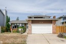 Brick and siding exterior featuring a two-car garage, concrete driveway, and front entry - 18316 78 Avenue Nw, Edmonton, AB  - Outdoor 