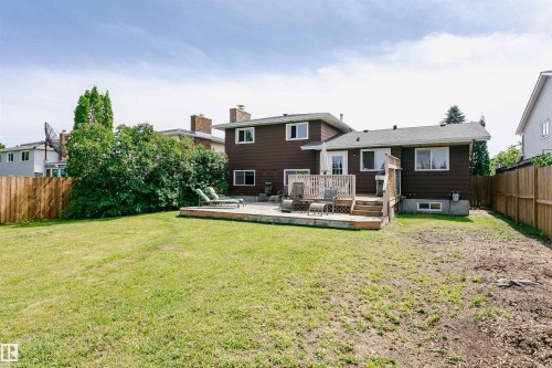 Expansive backyard featuring a multi-level wood deck, mature perimeter shrubs, and a wood fence - 18316 78 Avenue Nw, Edmonton, AB - Outdoor With Backyard With Exterior