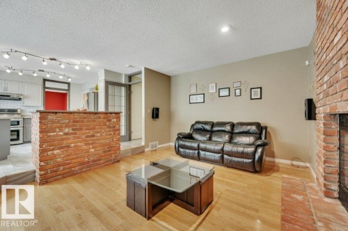 wired for surround sound - 568 Buchanan Road Nw, Edmonton, AB - Indoor Photo Showing Living Room With Fireplace