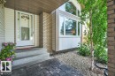 Front entry featuring a storm door, concrete steps, and an embossed concrete walkway - 568 Buchanan Road Nw, Edmonton, AB  - Outdoor With Exterior 