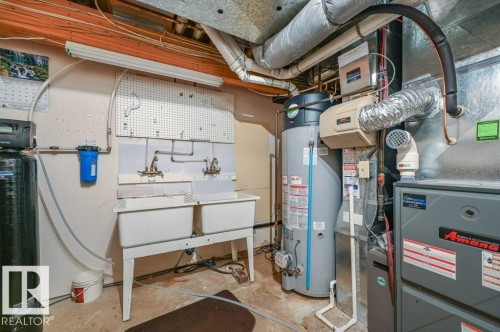 High efficiency furnace, hot water tank, water softener and water filter for drinking water - 568 Buchanan Road Nw, Edmonton, AB - Indoor Photo Showing Basement