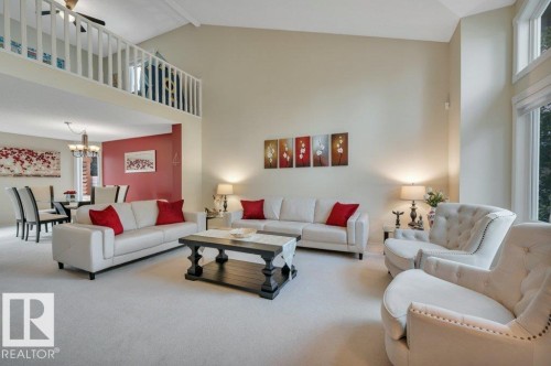 Two-story living area with vaulted ceilings & large windows - 568 Buchanan Road Nw, Edmonton, AB - Indoor Photo Showing Living Room