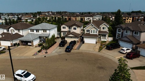 Two-story residence with a gray shingle roof, white exterior siding, and an attached two-car garage - 715 Wildwood Point(E) Nw, Edmonton, AB - Outdoor With Facade