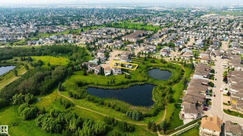 Aerial perspective showcasing a residential area with extensive green spaces and two prominent ponds - 715 Wildwood Point(E) Nw, Edmonton, AB - Outdoor With View