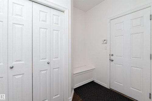 Entryway featuring a paneled door, built-in storage bench, and closet with bifold doors - 715 Wildwood Point(E) Nw, Edmonton, AB - Indoor Photo Showing Other Room