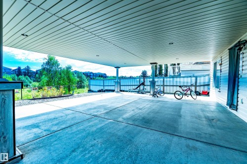 Expansive concrete patio with a covered ceiling featuring recessed lighting - 715 Wildwood Point(E) Nw, Edmonton, AB - 
